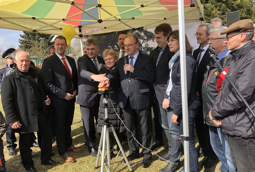 Daniel Knohr (Regionalleiter aconium, hoheitlich beliehener Projektträger des Bundesministeriums für Verkehr und digitale Infrastruktur, 2.v.l.), Manfred Behrens (MdB, 3.v.l.), Bürgermeisterin Steffi Trittel (Hohe Börde, 4.v.l.), Ministerpräsident Dr. Reiner Haseloff (Sachsen-Anhalt, 5. v.l.) und weitere Teilnehmer bei der Inbetriebnahme des Breitbandnetzes in der Gemeinde Hohe Börde (Sachsen-Anhalt) am 26.03.2018